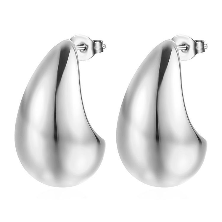 Pair of polished silver teardrop stud earrings with butterfly backs on white background