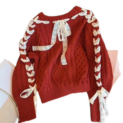 Red sweater with decorative ribbons on a white background