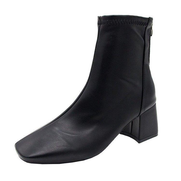 Black leather ankle boot with block heel and back zipper, sleek modern design