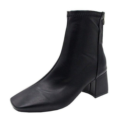 Black leather ankle boot with block heel and back zipper, sleek modern design