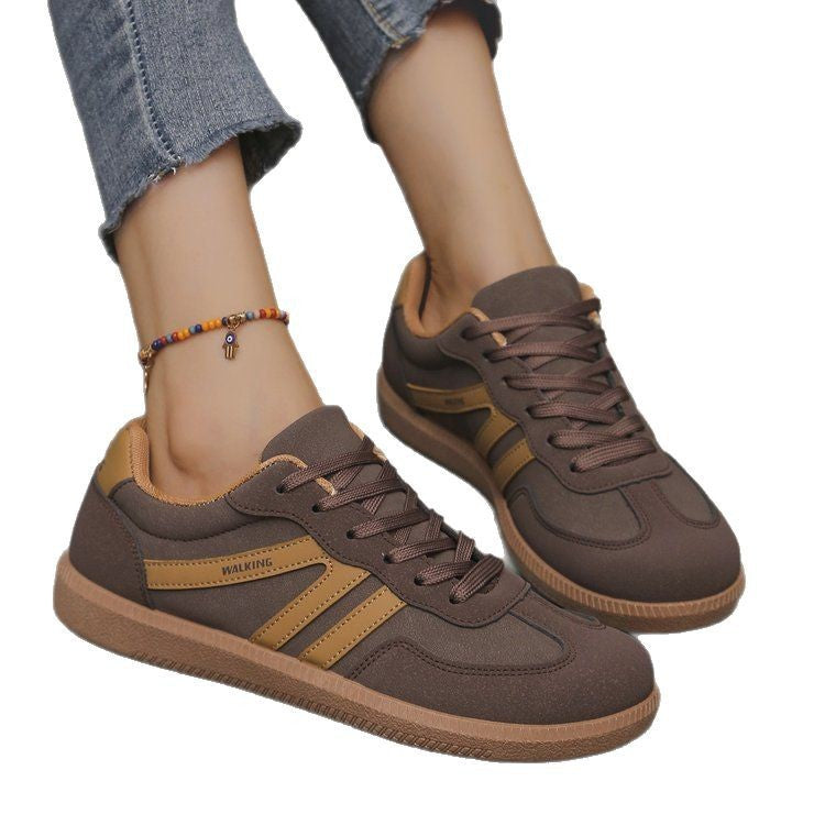 Brown and tan casual walking sneakers on feet with frayed hem jeans and colorful beaded anklet