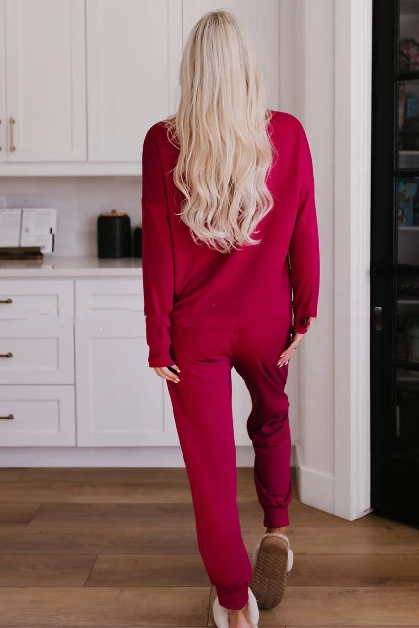 Person wearing a red tracksuit in a kitchen setting