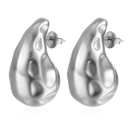 Pair of silver abstract organic-shaped stud earrings with shiny, smooth textured surface