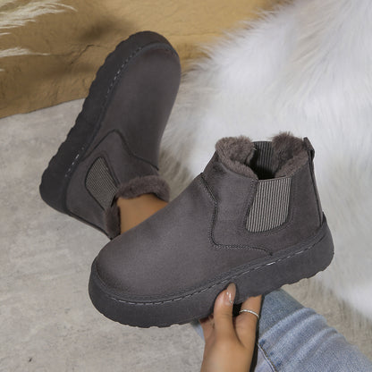 Dark grey suede winter ankle boots with fur lining and elastic side panels worn with jeans
