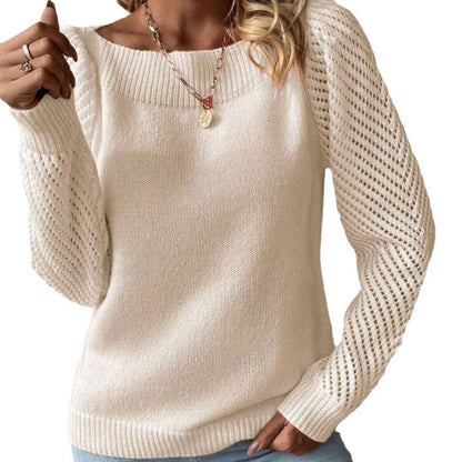 Woman wearing a white knit sweater with openwork long sleeves and ribbed neckline