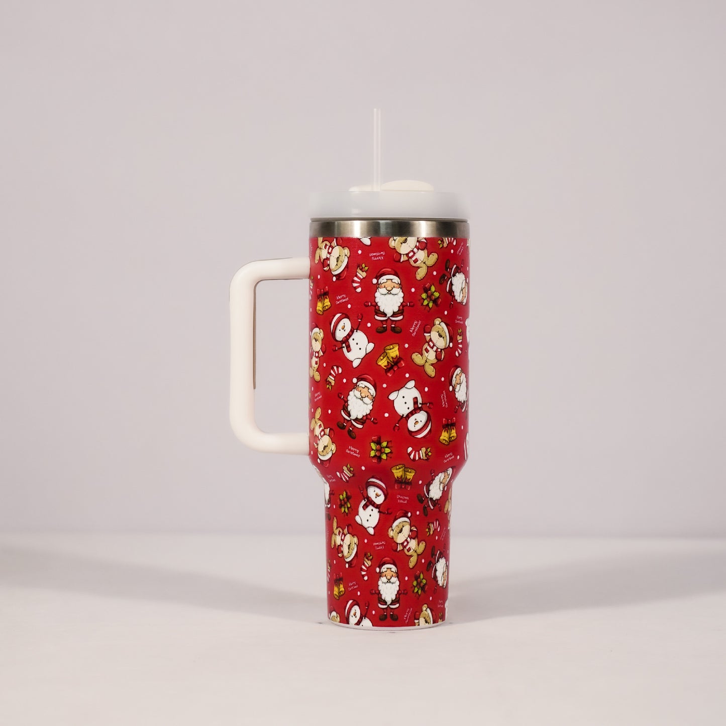 Red tumbler with Christmas-themed design on a gray background