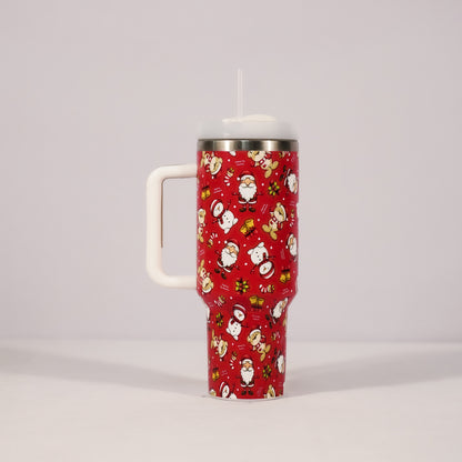 Red tumbler with Christmas-themed design on a gray background